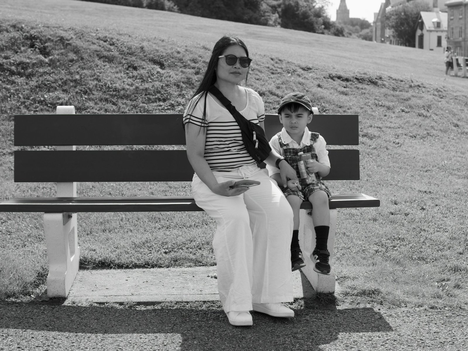 Woman and child sitting on park bench