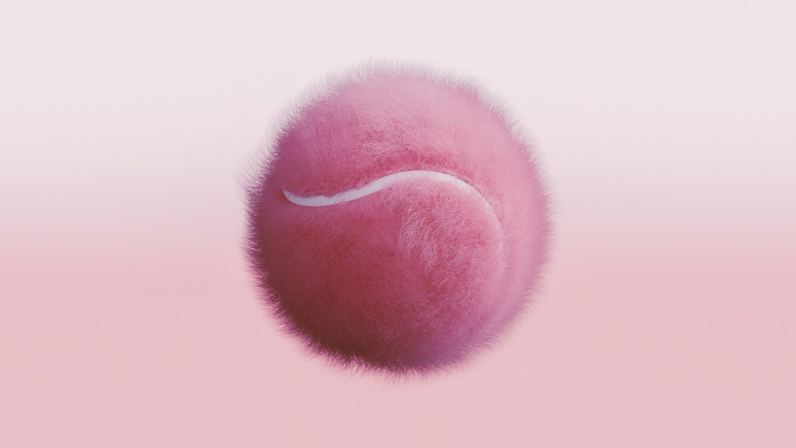 A pink tennis ball flying through the air