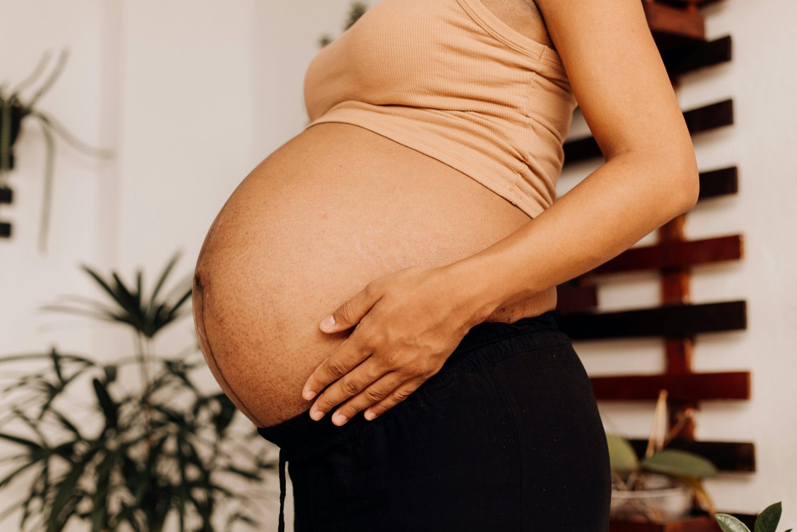 a pregnant woman holding her belly in her hands