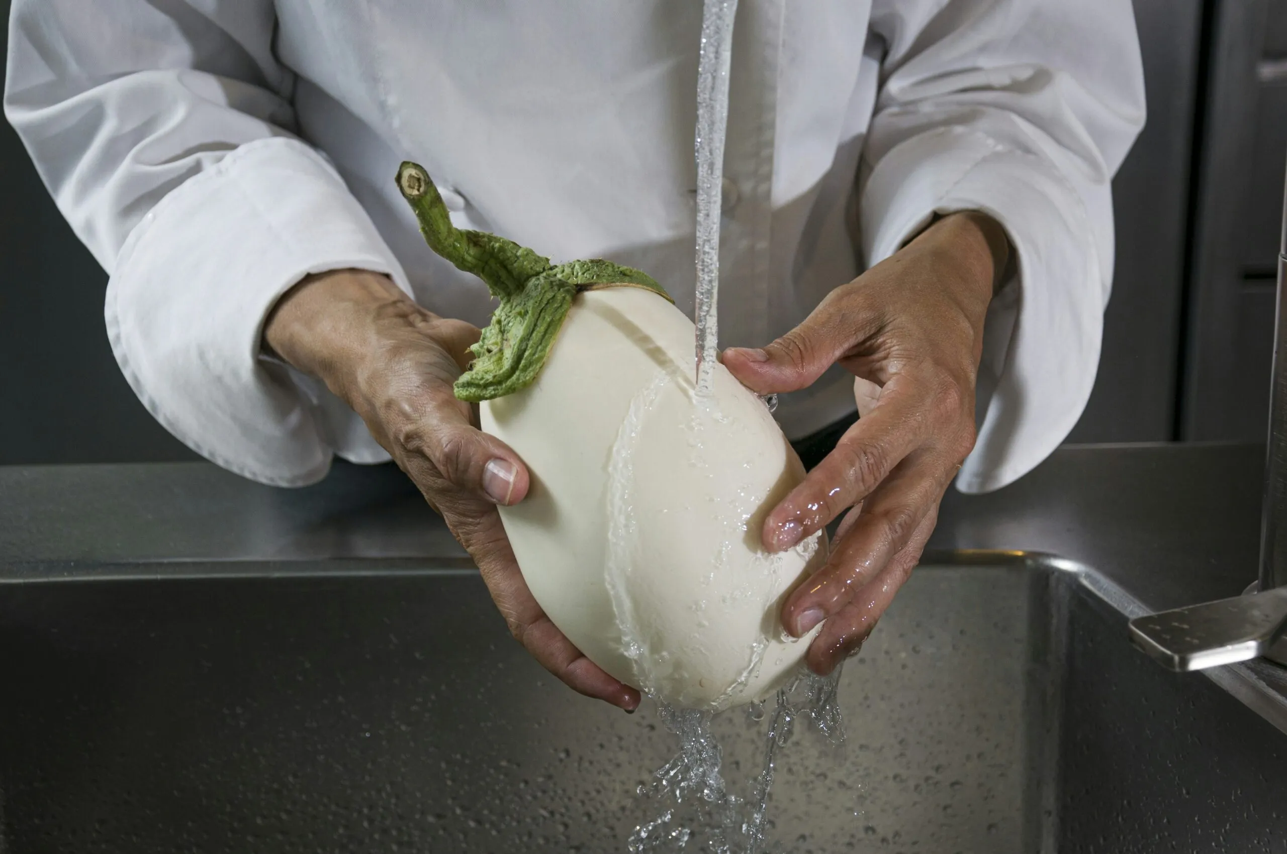 a person in a white shirt is holding a water jug