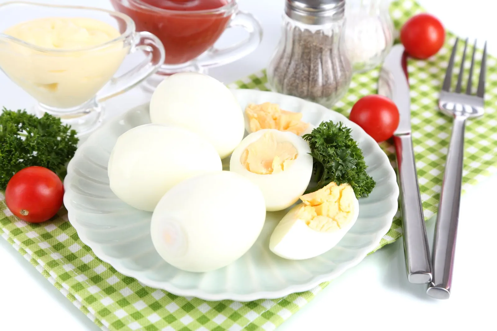 Boiled eggs on plate on napkin isolated on white