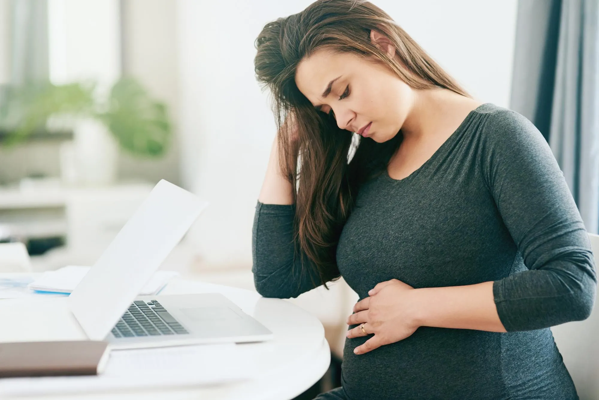 Business stress and pregnant woman with laptop in office overthinking stomach pain mistake or fear Pregnancy anxiety and girl entrepreneur with belly ache nervous and overwhelmed by fatigue