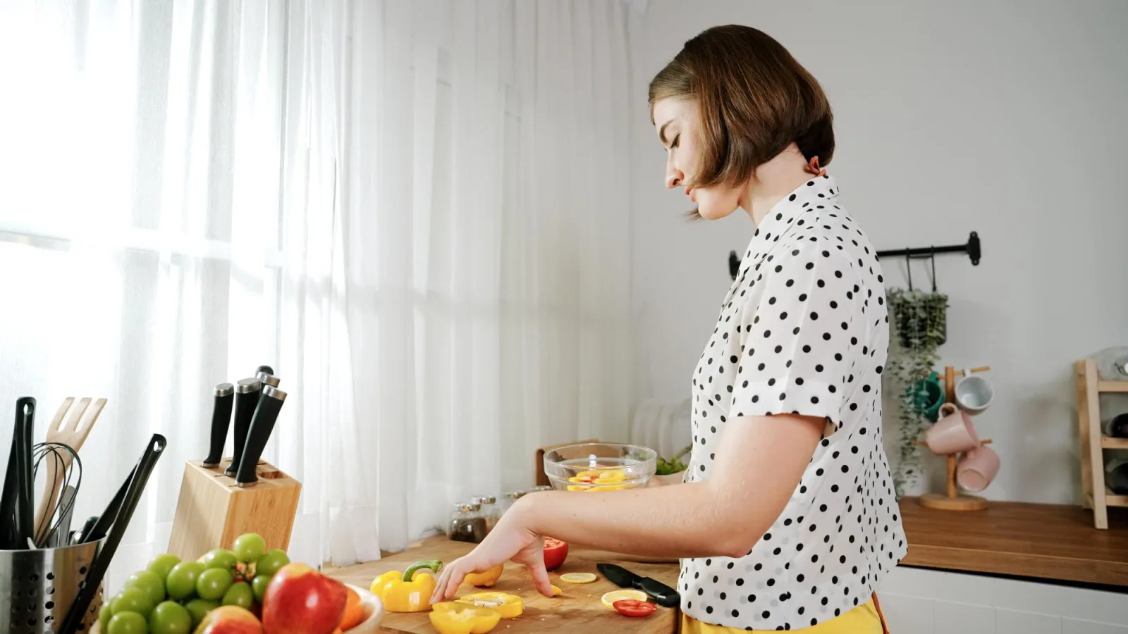 Caucasian mother put vegetable in bowl making a salad for breakfast pedagogy