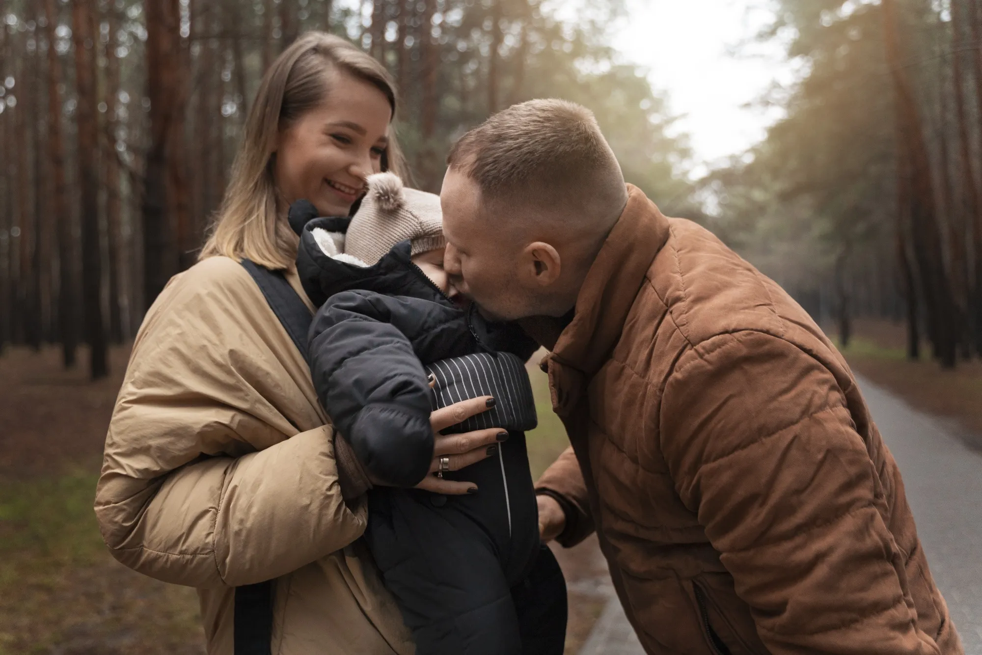 Couple with baby outdoors medium shot