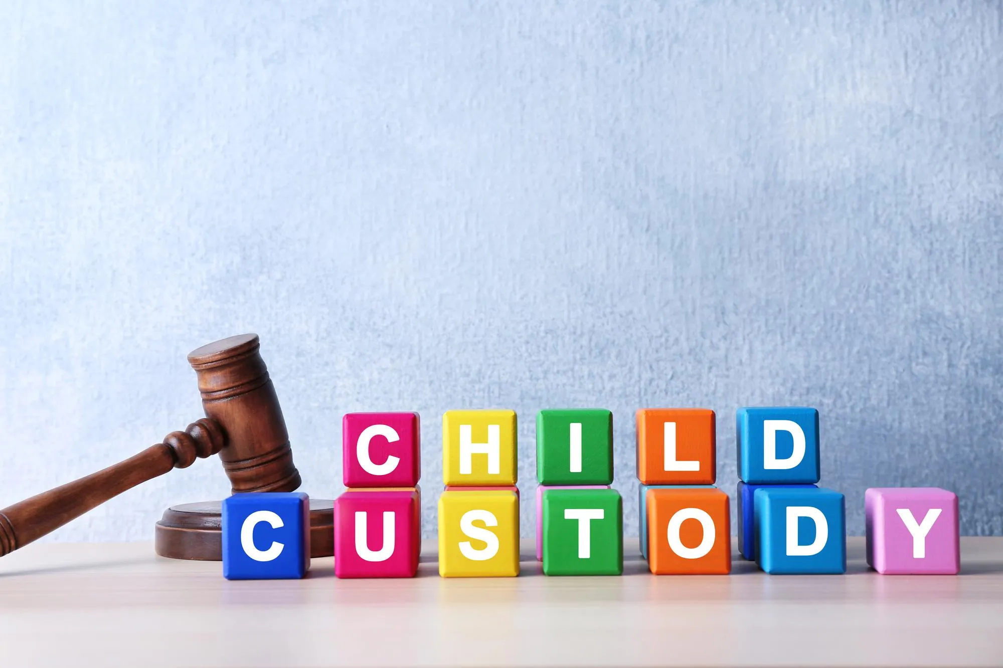 Court gavel and cubes with text CHILD CUSTODY on light background