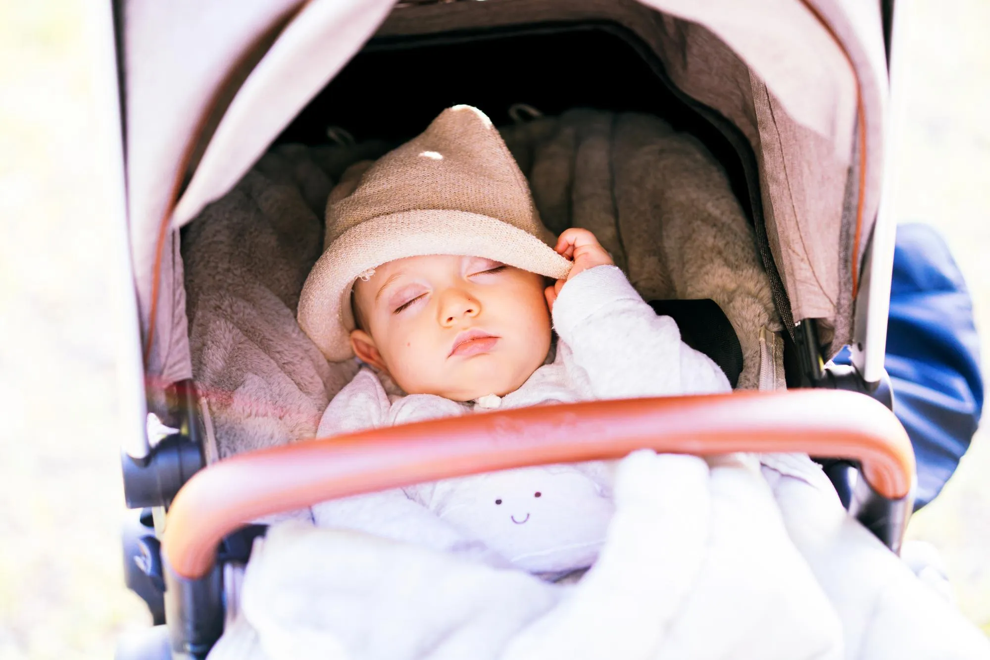 Cute baby sleeping in stroller outdoors