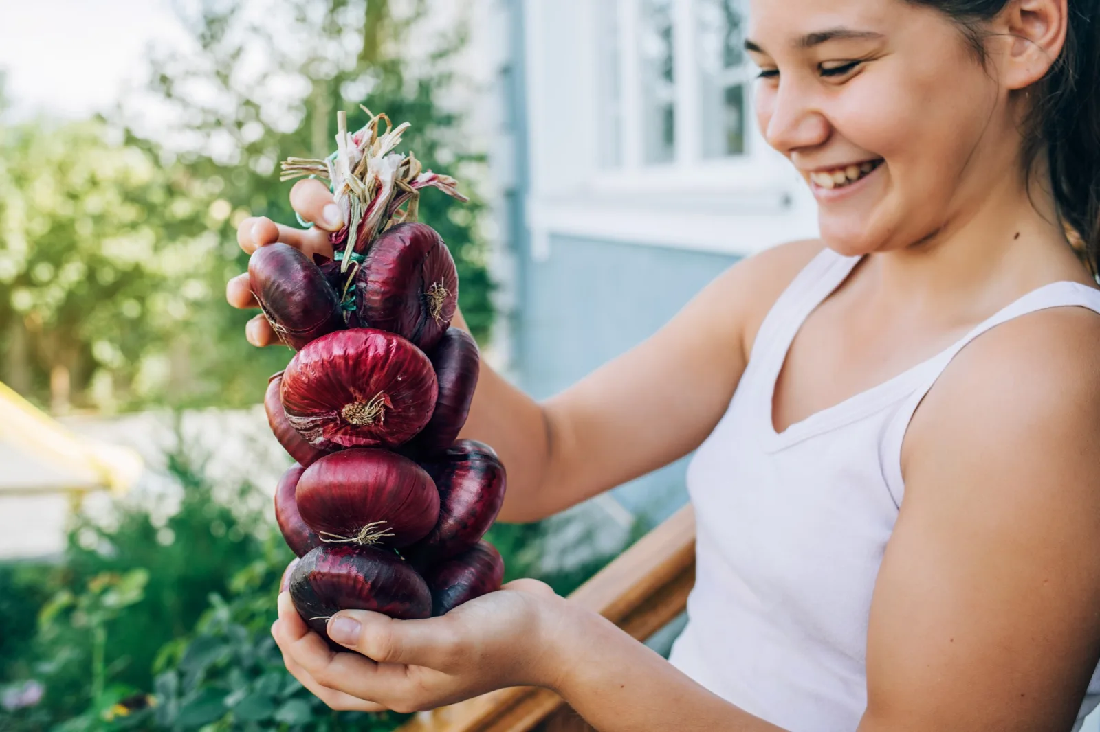 Female hands hold an onion . harvesting, organic food.
