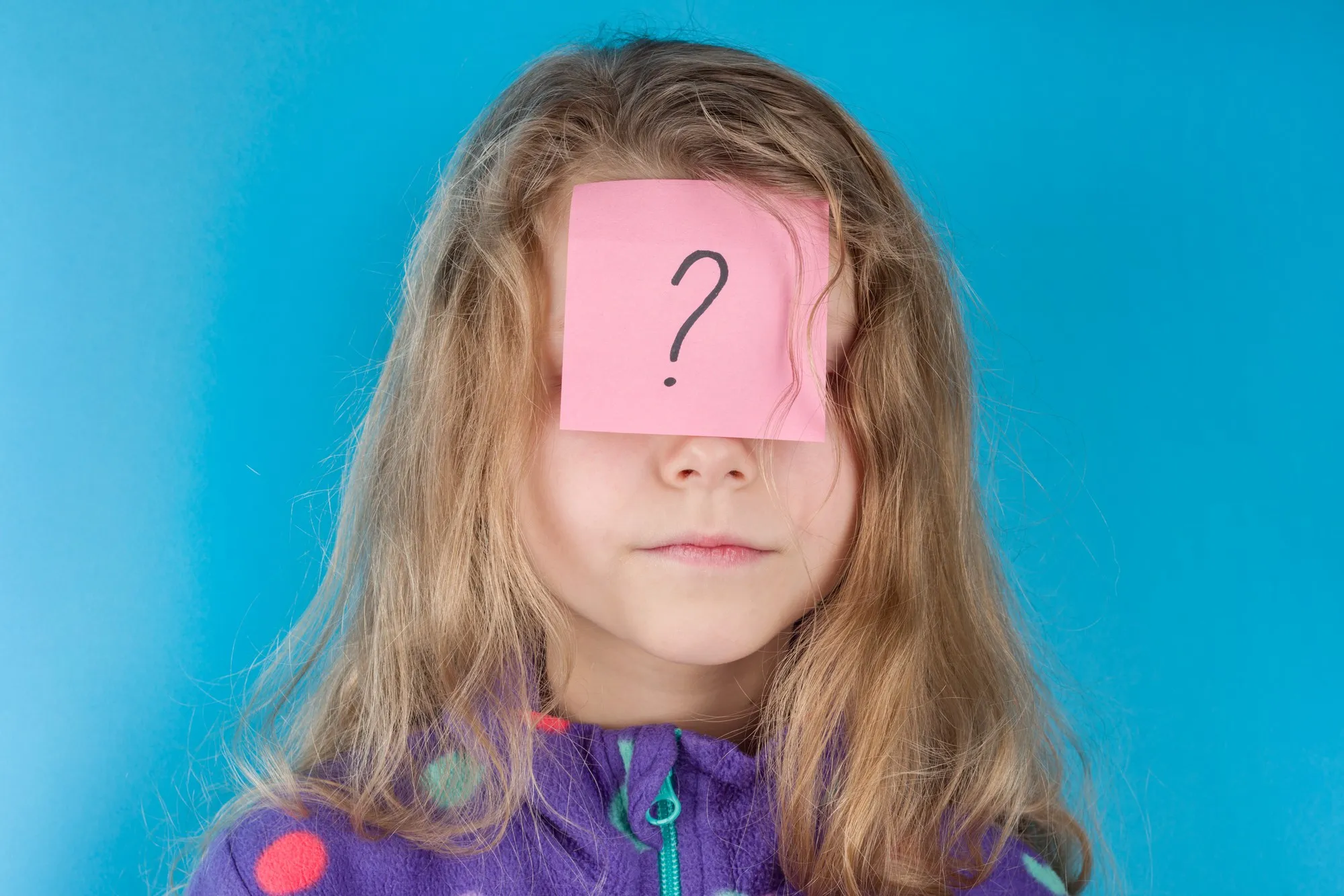Girl and sticker question mark on forehead
