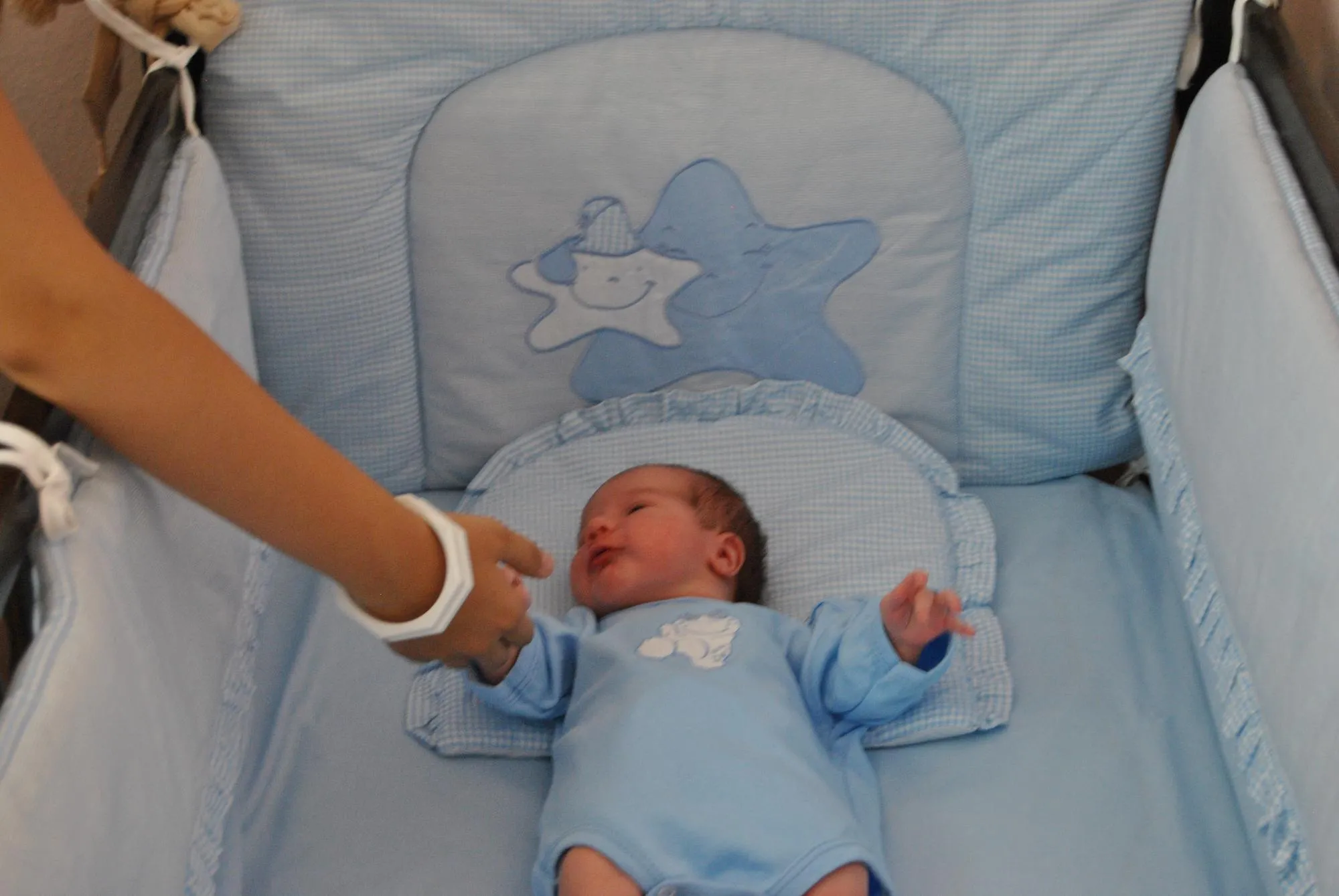 High angle view of child lying in crib