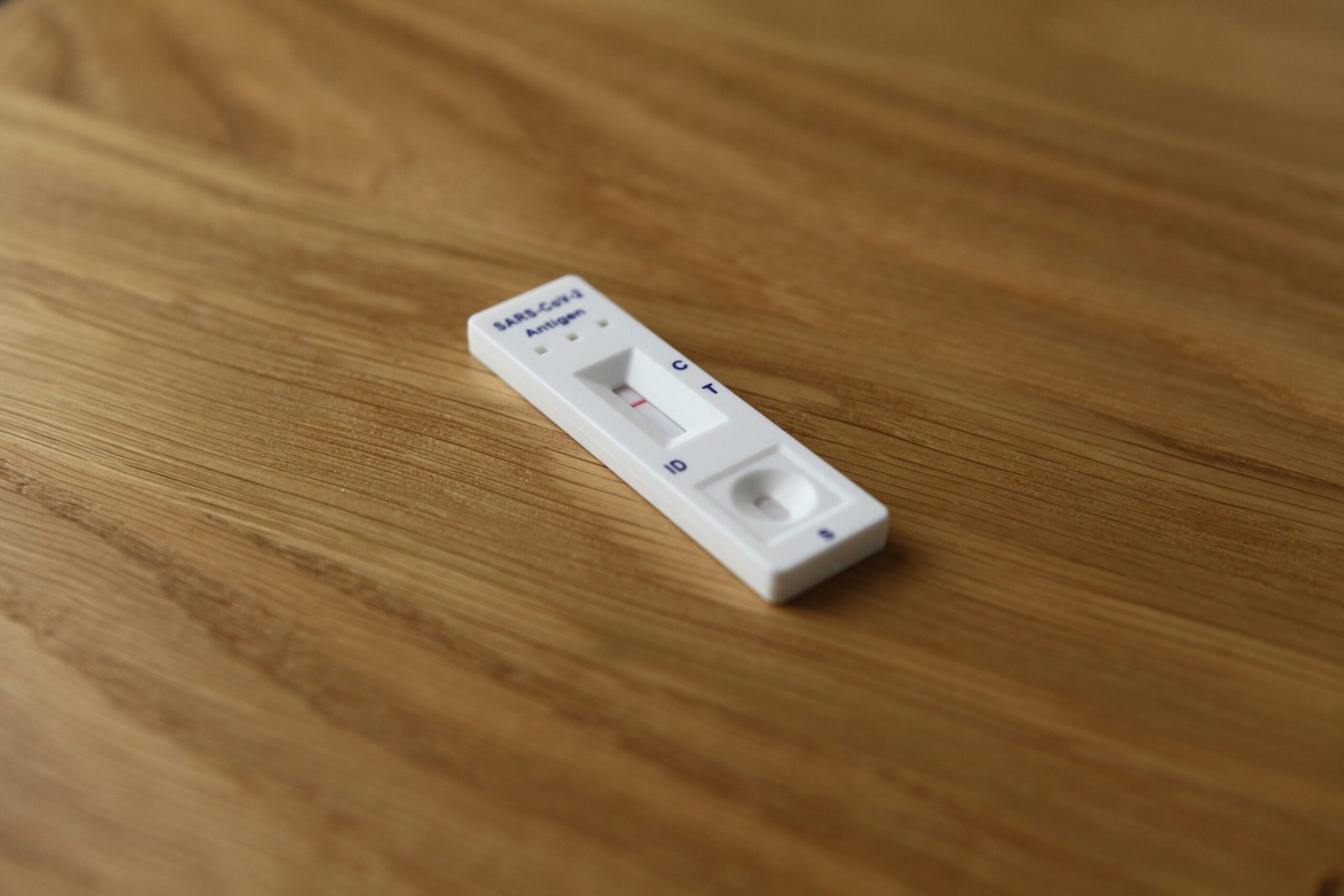 a remote control sitting on top of a wooden table