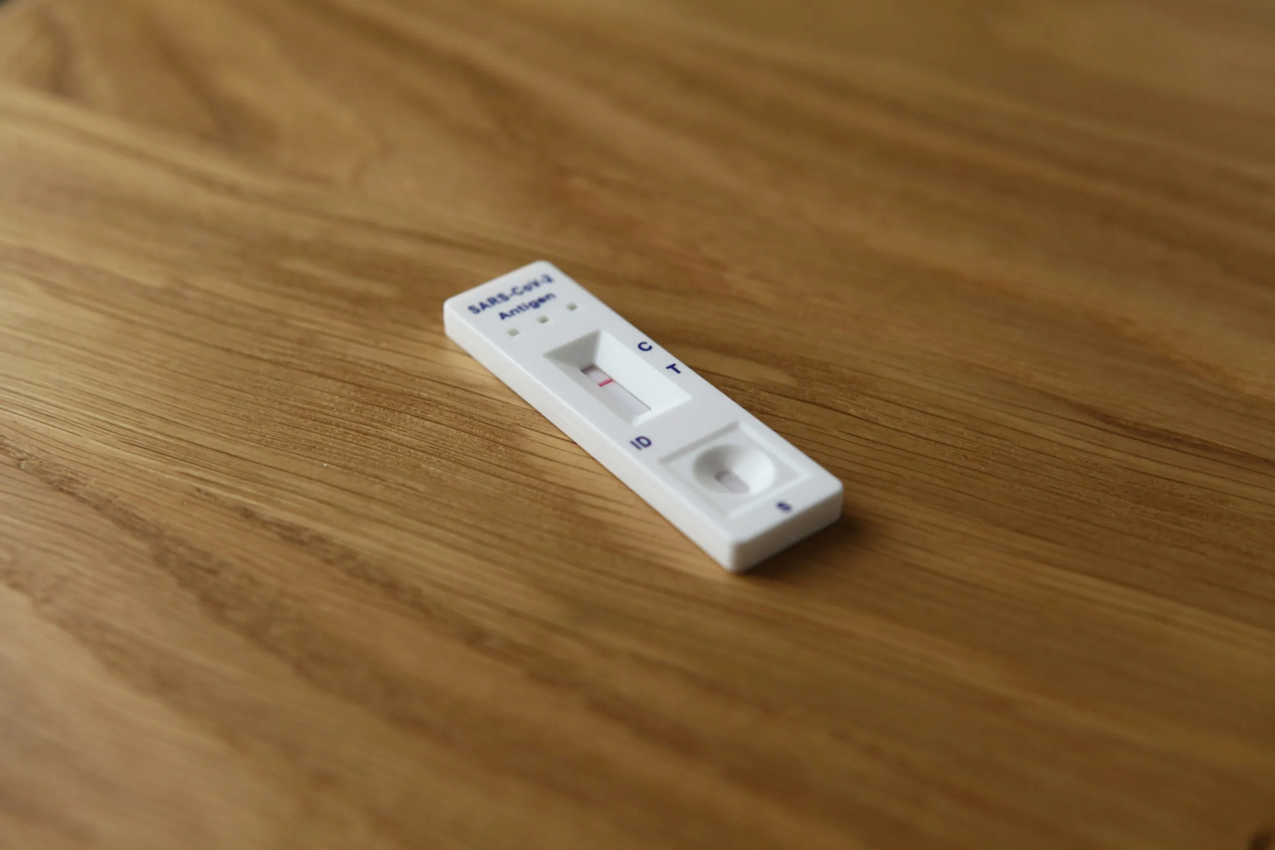 a remote control sitting on top of a wooden table
