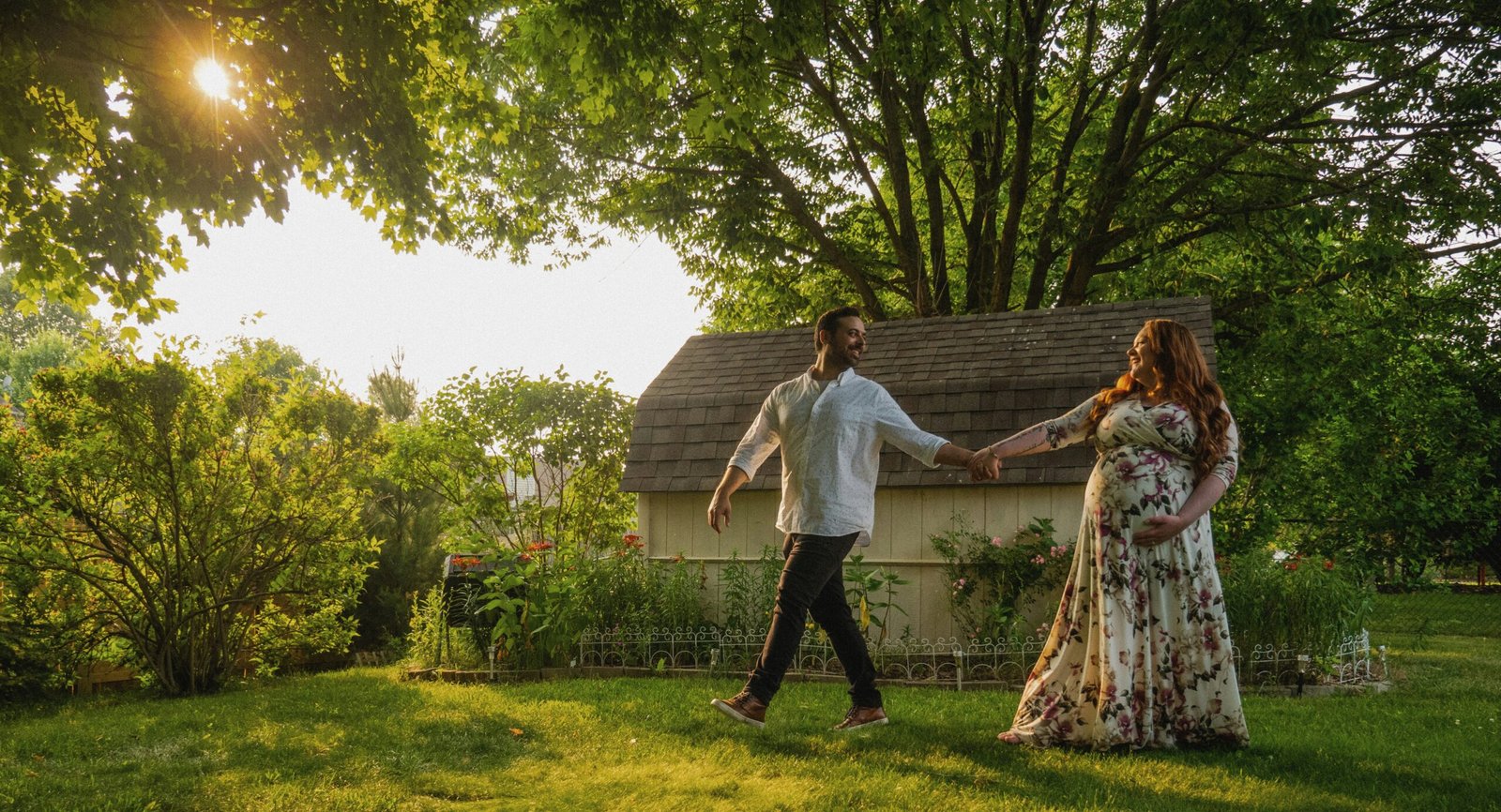 a man and a woman holding hands in front of a house