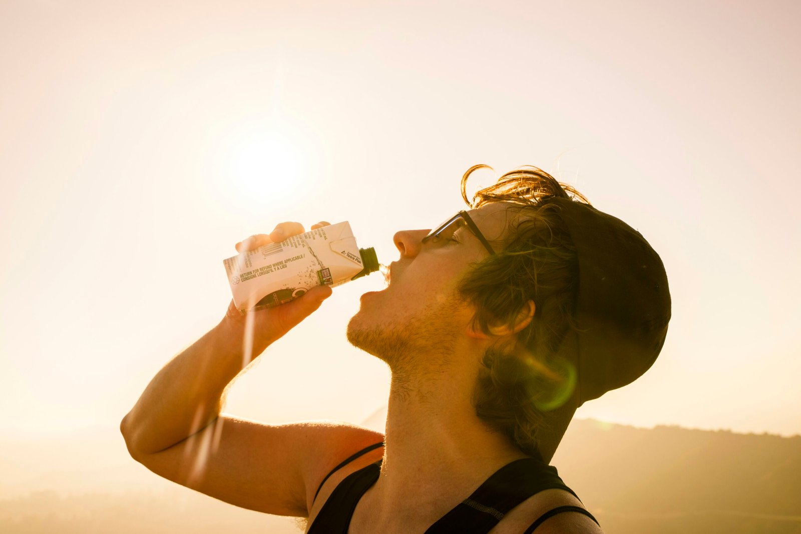 a man drinking from a bottle of water