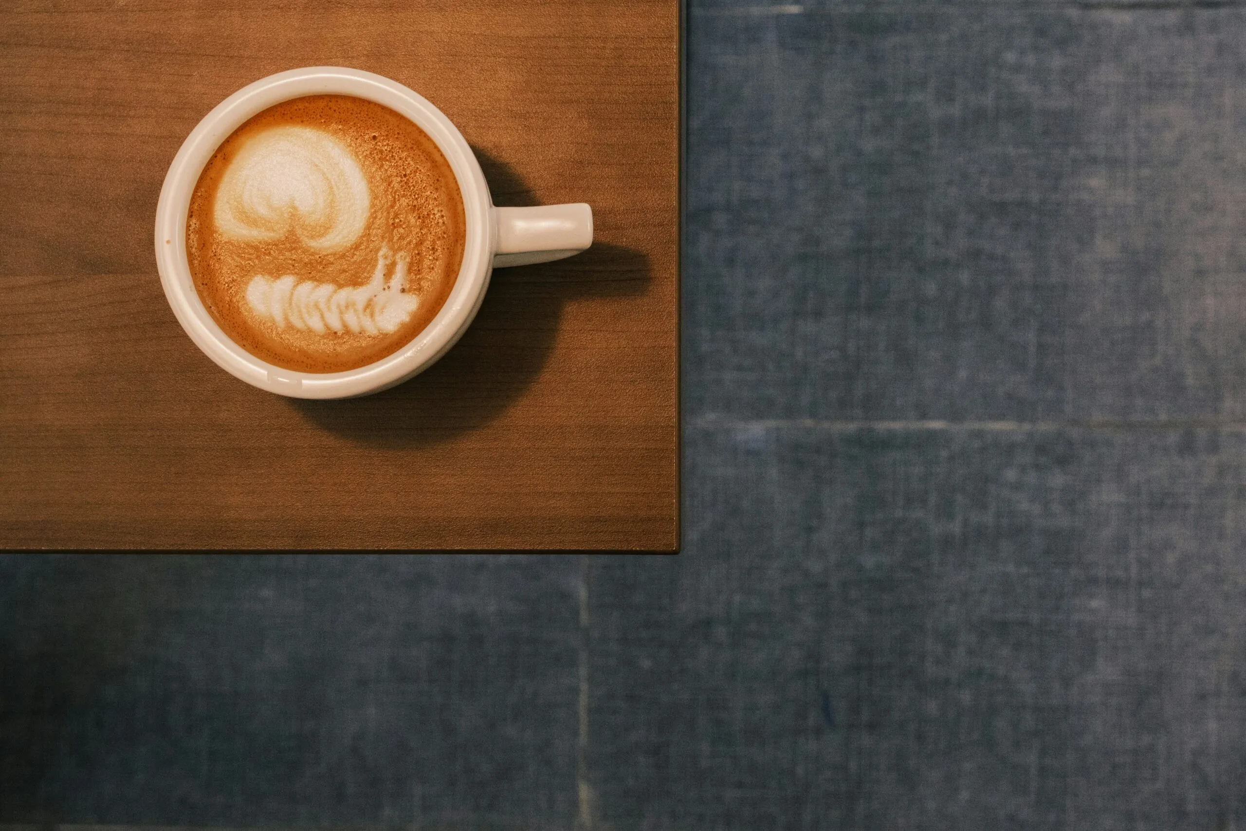 A cup of coffee sitting on top of a wooden table