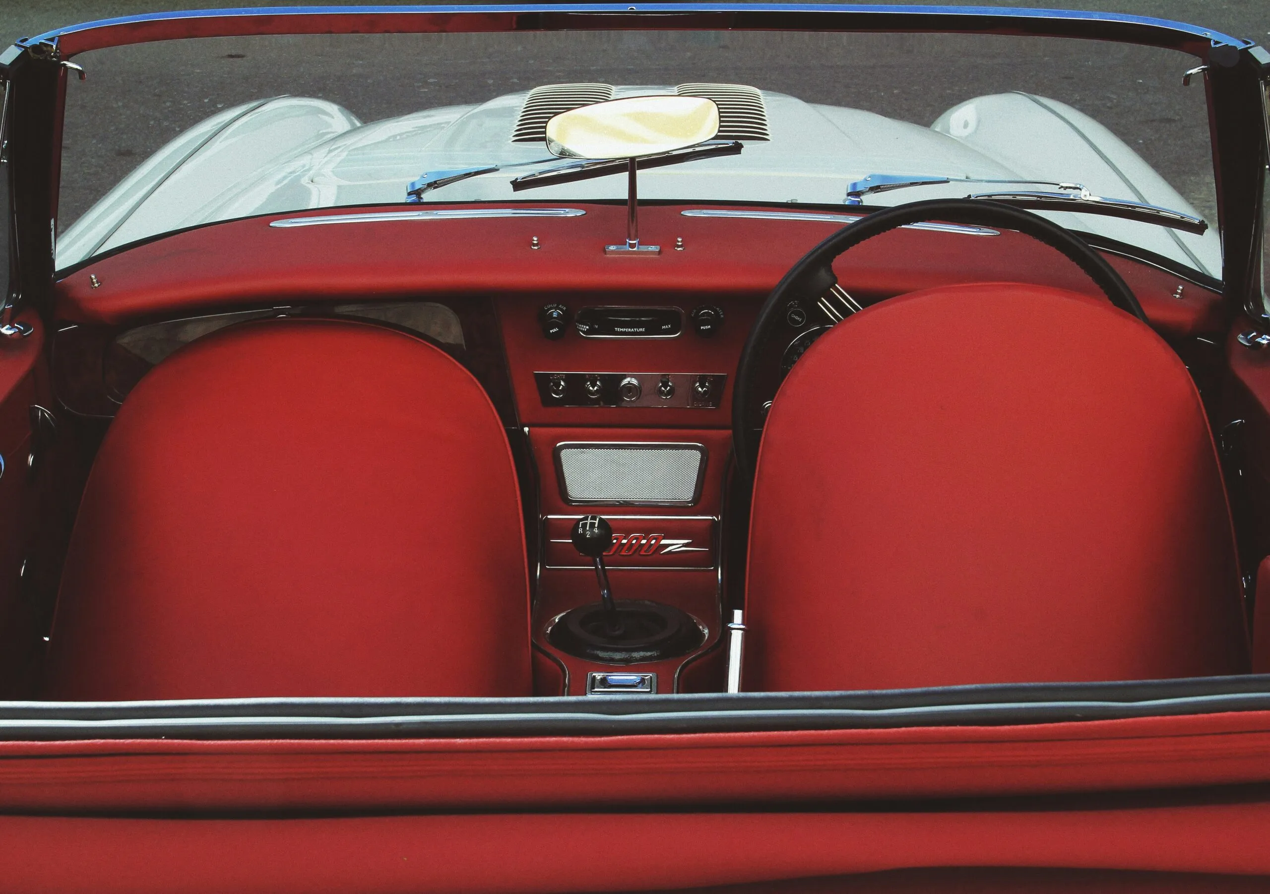 A red convertible car with the top down