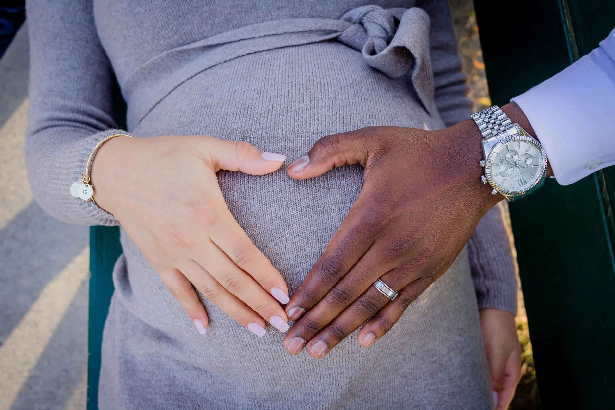 a pregnant woman is holding her husband's hand