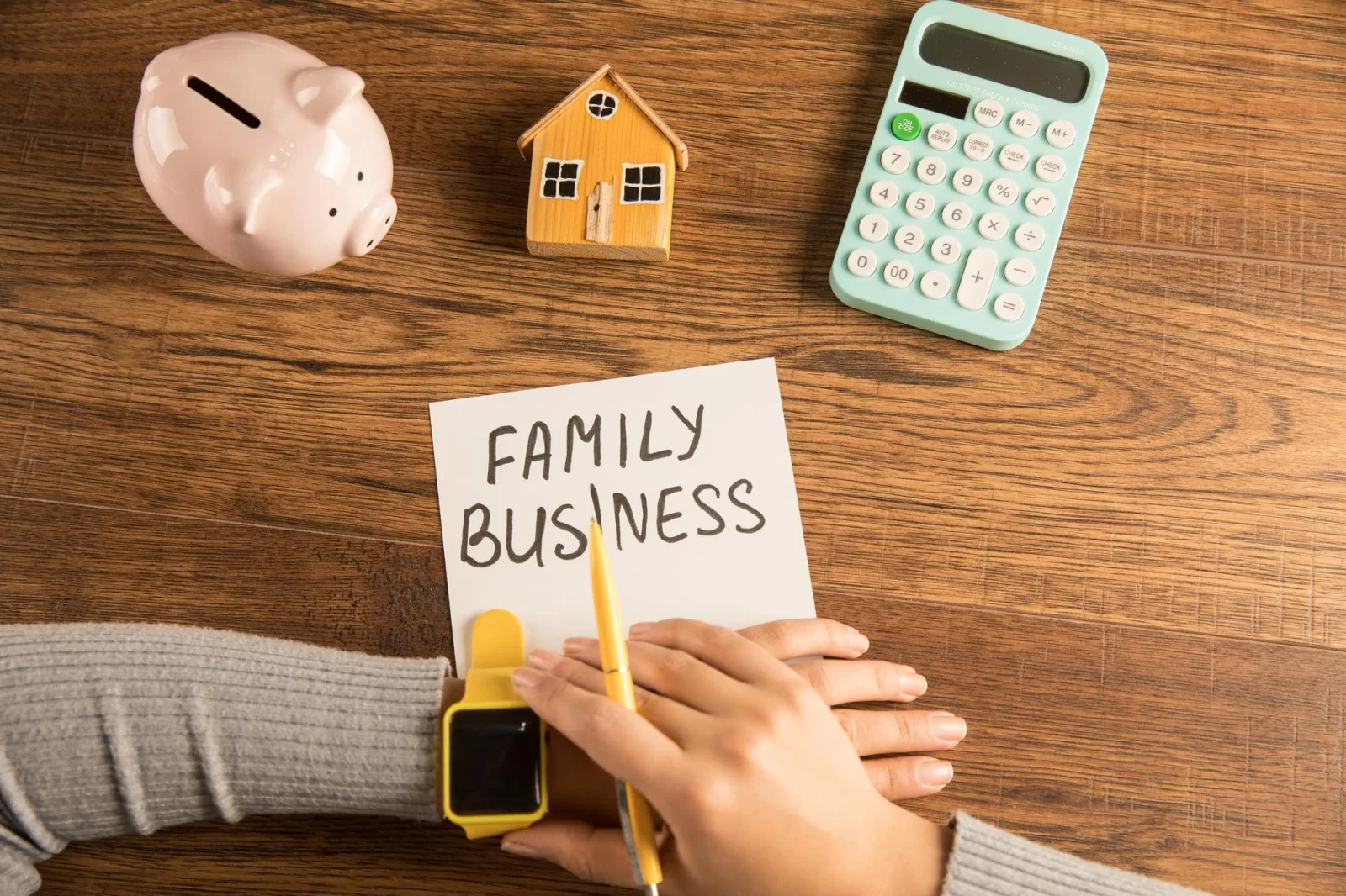 The inscription is a family business next to a droplet a house and a calculator woman looking at the time