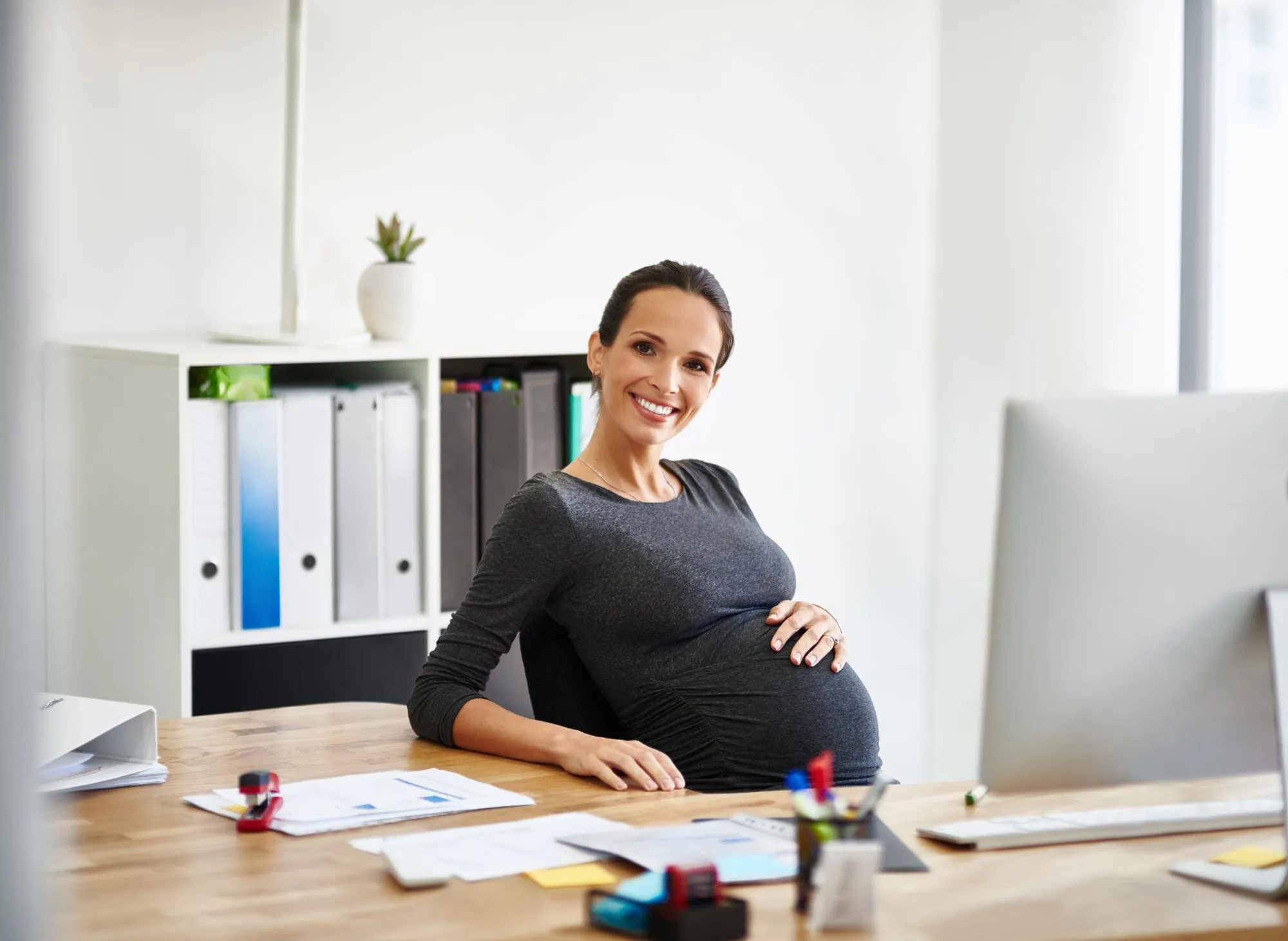 My next job is becoming a mother Portrait of a pregnant businesswoman working in an office