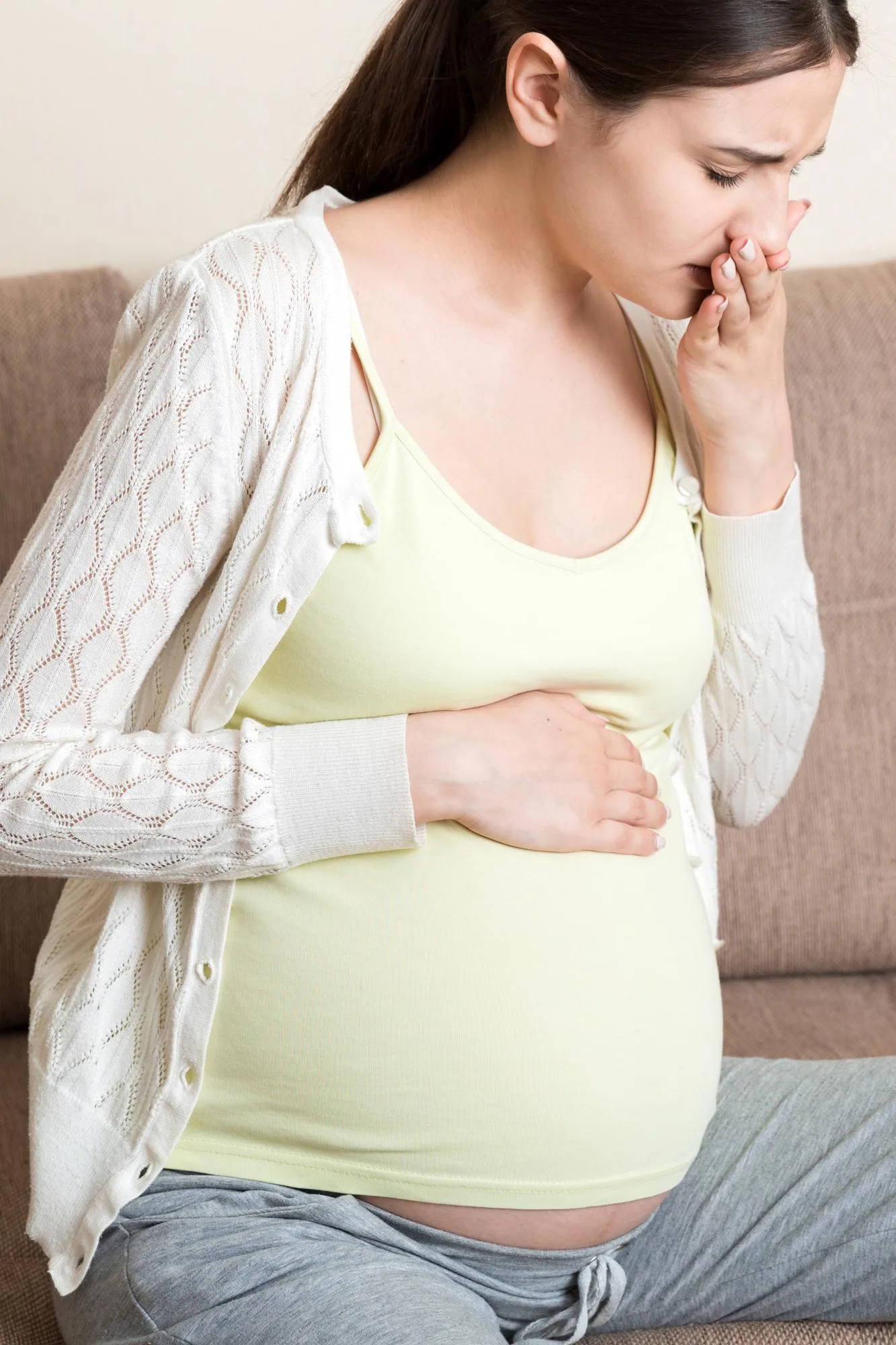 Pregnancy Morning Sickness Pregnant Woman Having Nausea Feeling Bad in Sofa at the Home