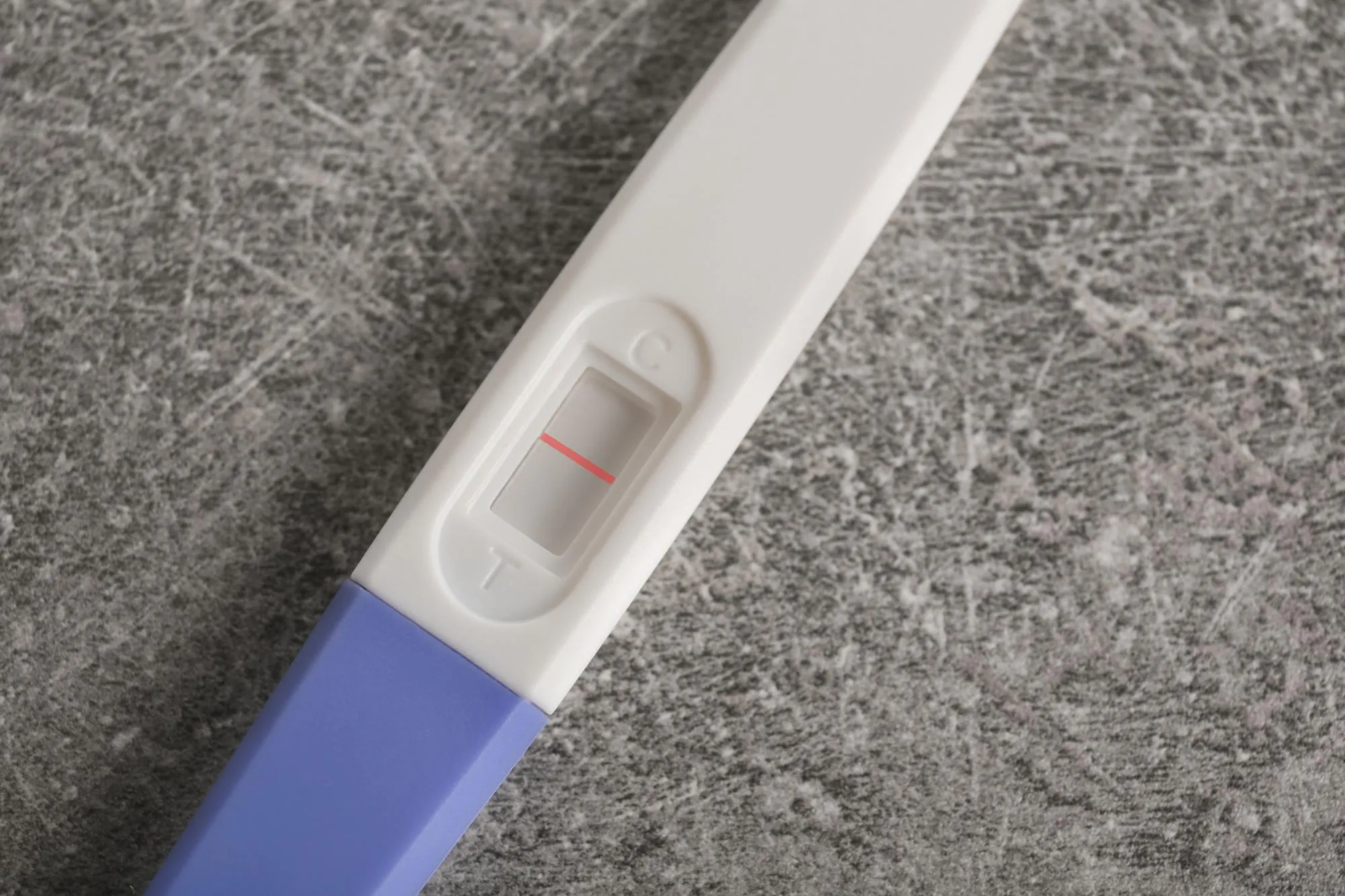 Pregnancy test on grey background
