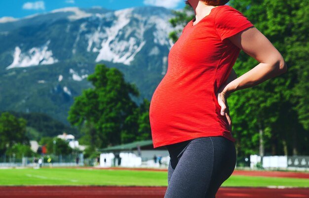 pregnant sporty fitness woman suffering lower back pain Sport healthy lifestyle while pregnancy
