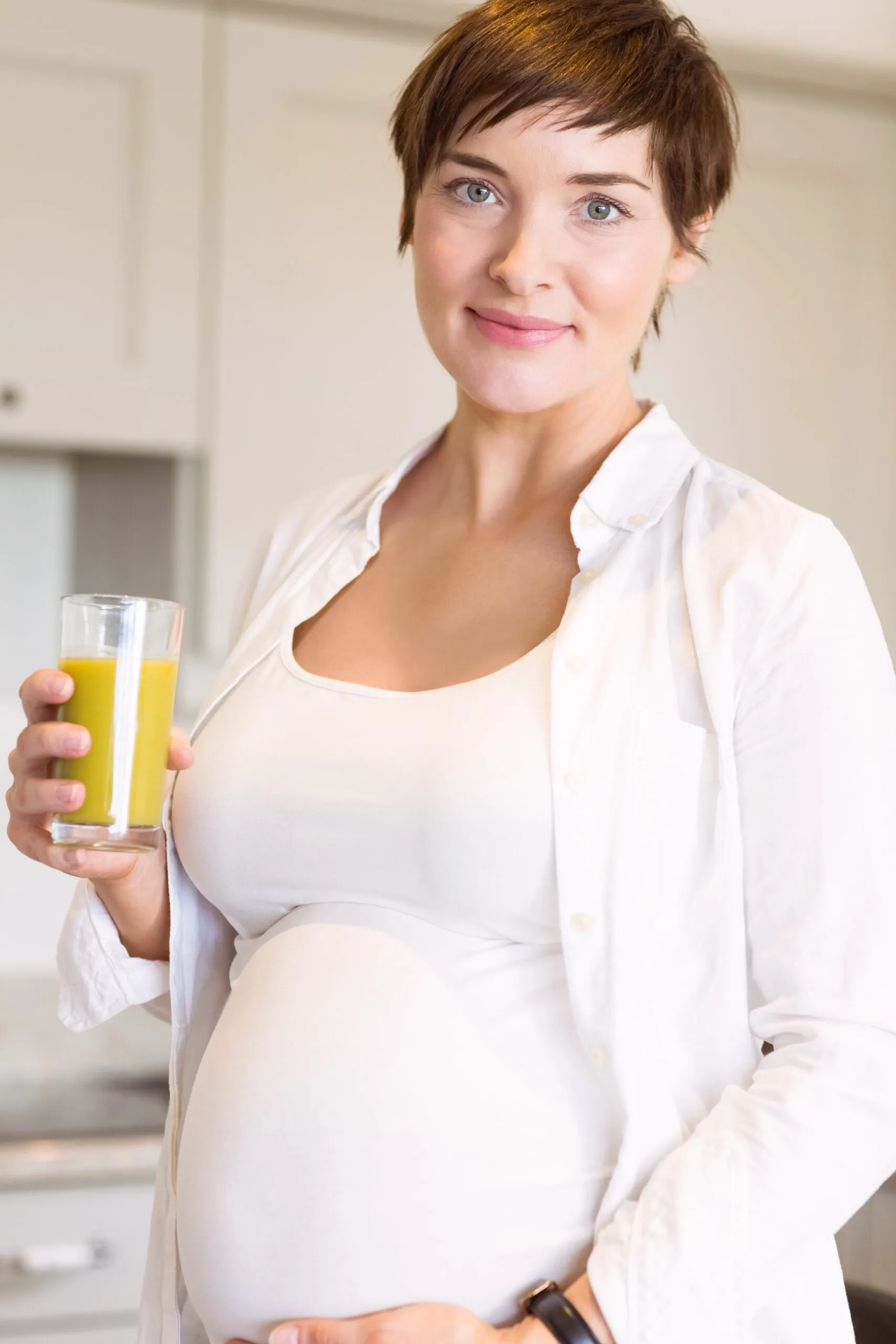 Pregnant woman having a glass of orange juice