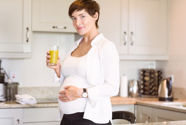 Pregnant woman having a glass of orange juice