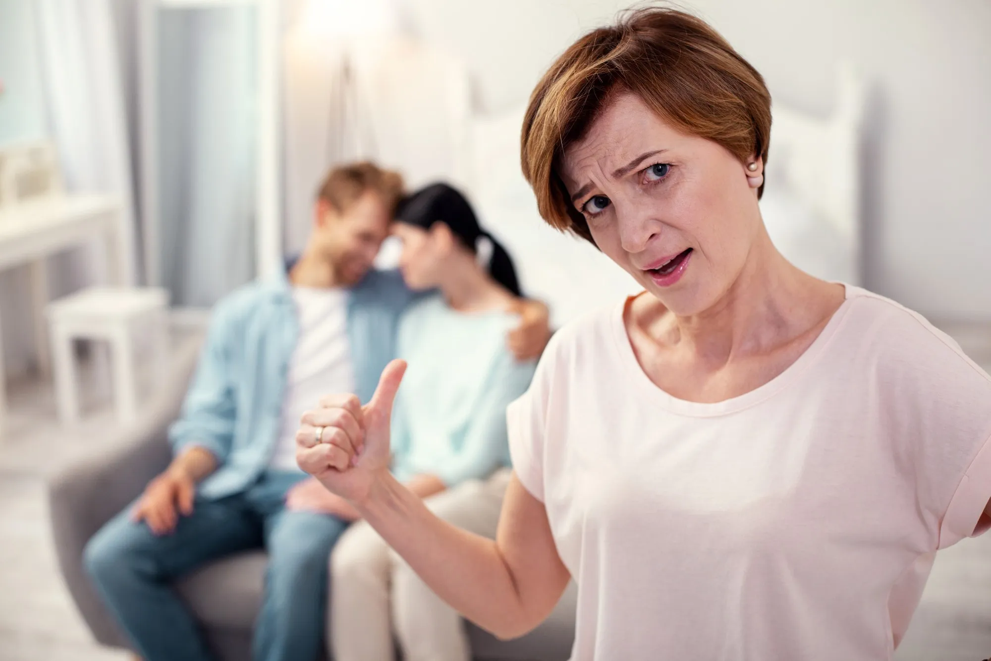 Unhappy mother in law. Cheerless aged woman looking at you while worrying about her son