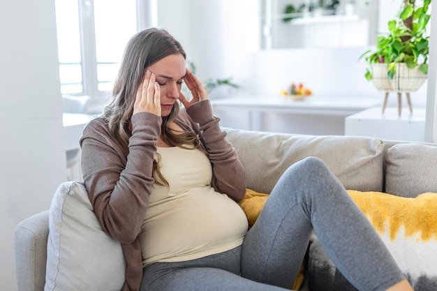 Upset depressed pregnant woman feeling strong headache migraine sad tired drowsy exhausted woman