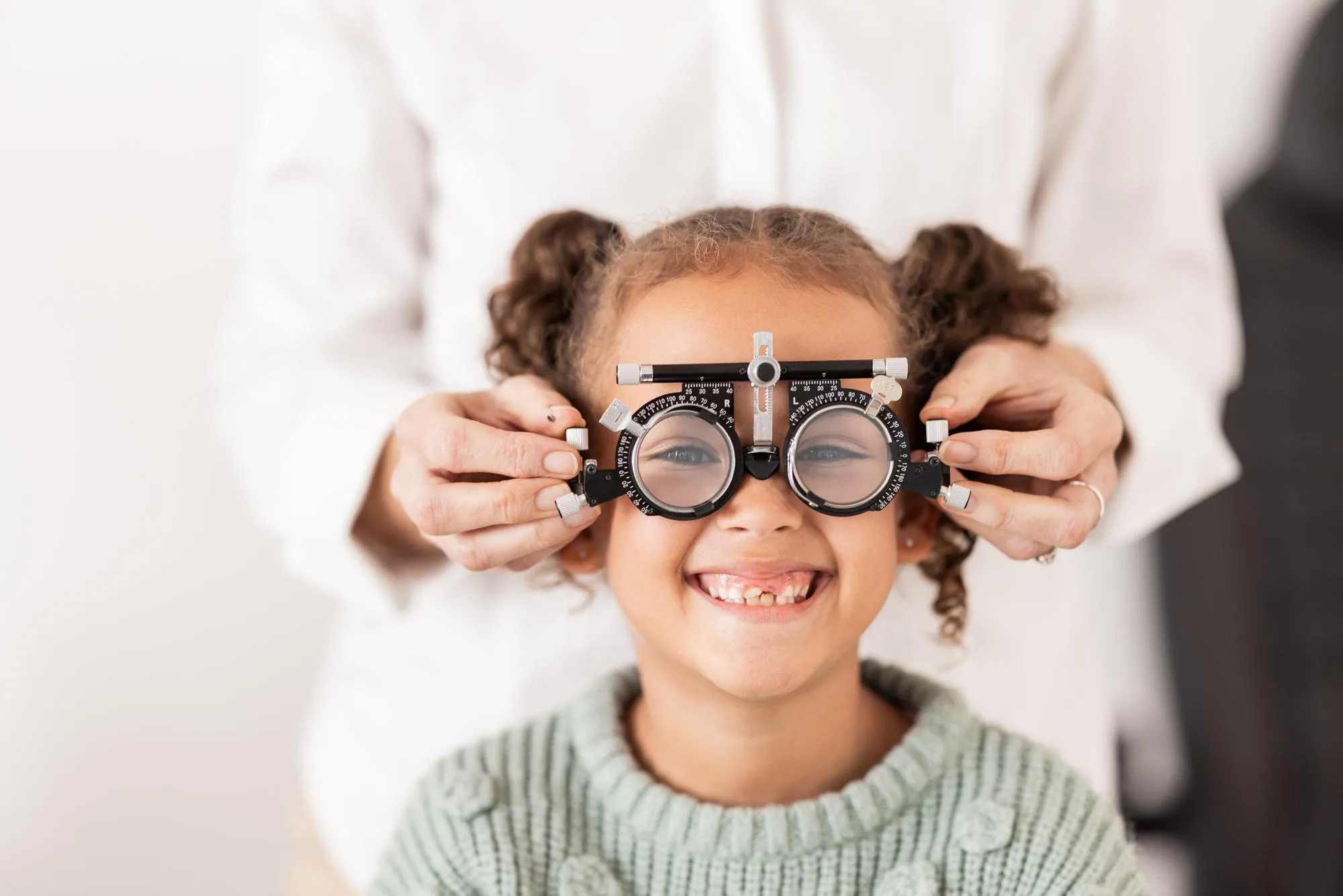 Vision optometrist and portrait of child with glasses to test check and examine eyesight Healthcare medical and young girl in doctor office for eye examination optical diagnostic and examination