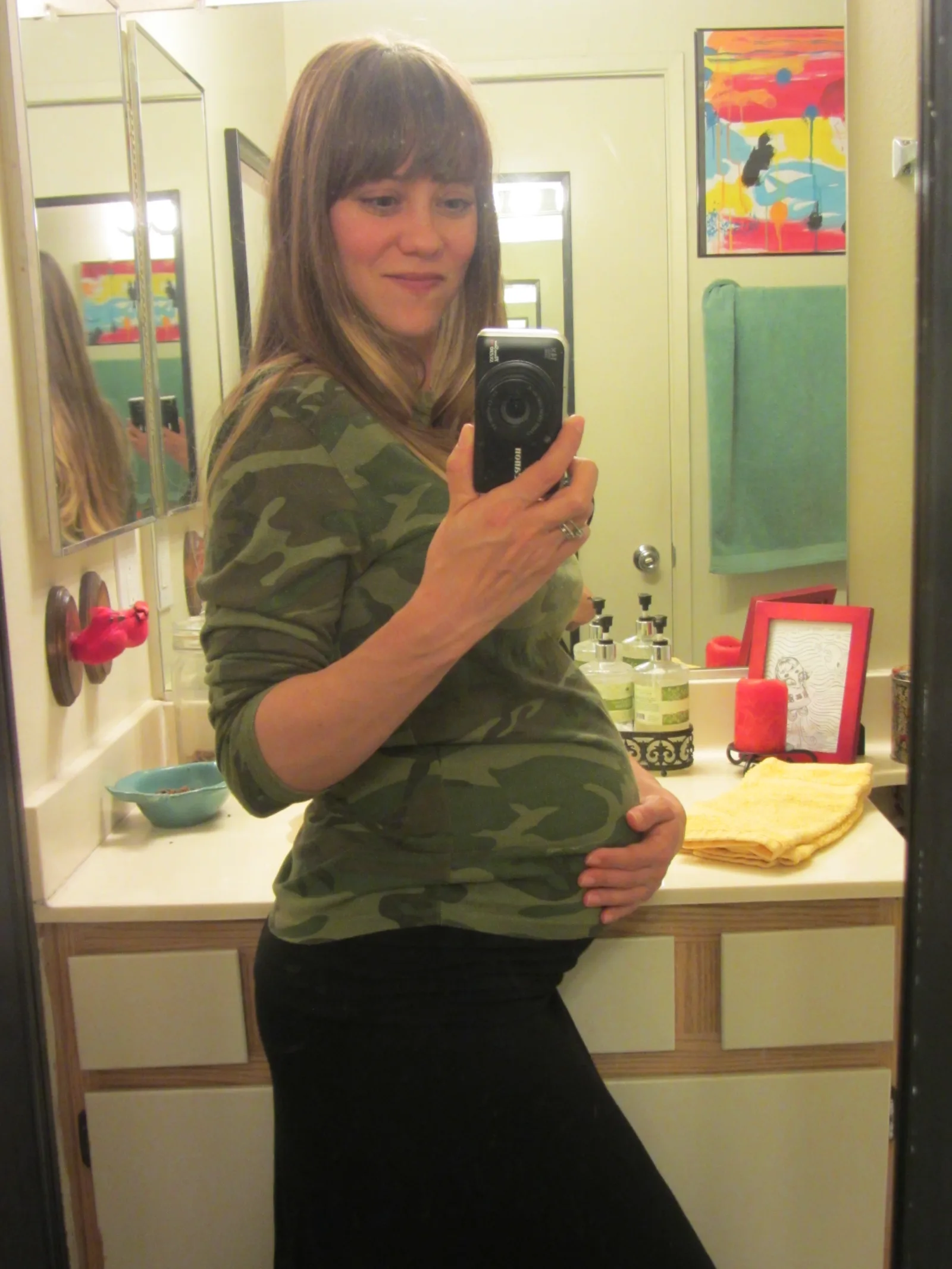 Niblet is about 13 1/2 inches long and weighs about 1 1/2 pounds. She's starting to get some baby fat! Apparently we'd be able to see the color and texture of her hair now, if we could see her. I'm guessing she'll be dark-haired a birth and lighter-haired as a littleun. We shall see...
All I'm doing lately is studying for the baby bar on Oct. 22. Always love it when she interrupts my study sessions to kick and kick and kick. I just sit back and relax and enjoy it. Best way to recharge ever. 
The belly is finally making it impossible to bend over, or see my feet from a standing position, or see my crotch ever (hello 1970s!!), or get a decent night sleep. After two nights of tossing and turning and NOT sleeping (and keeping Mike awake - poor man), Mike bought me a body pillow. It is now my favorite thing of all the things. I never knew I could love an inanimate object so much. But seriously, one night with it and I felt like a new woman. Oh the wonder of a well-supported sleep.... 

CANNOT WAIT TO START NESTING OMG.