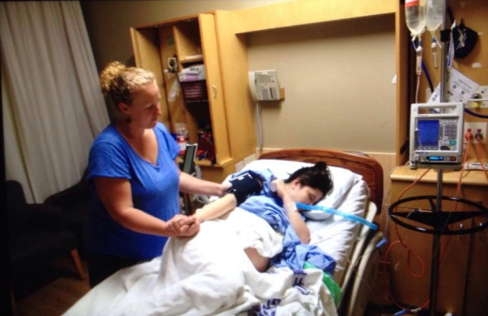 Doula (L) working with family during labor