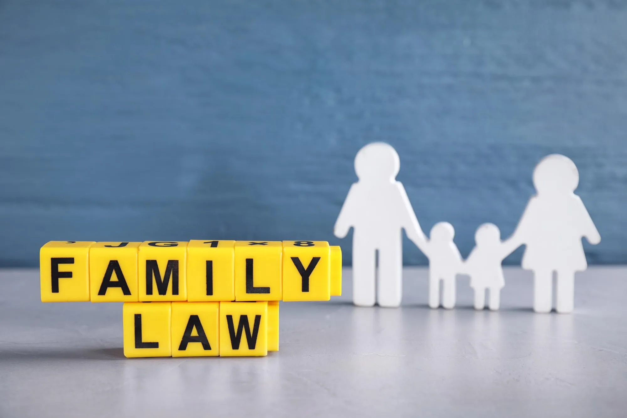 Cubes with letters and family figure on light table Family law concept