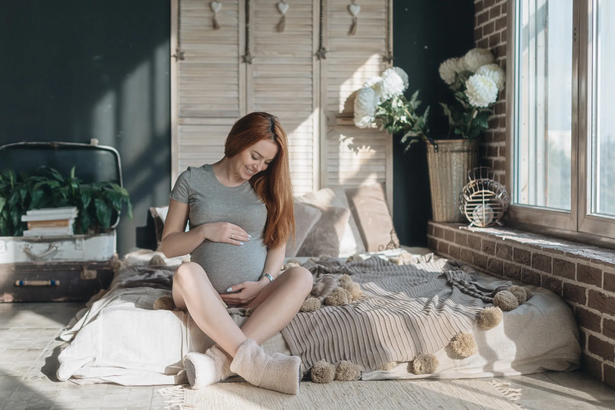 Pregnant woman touching and looking to her belly