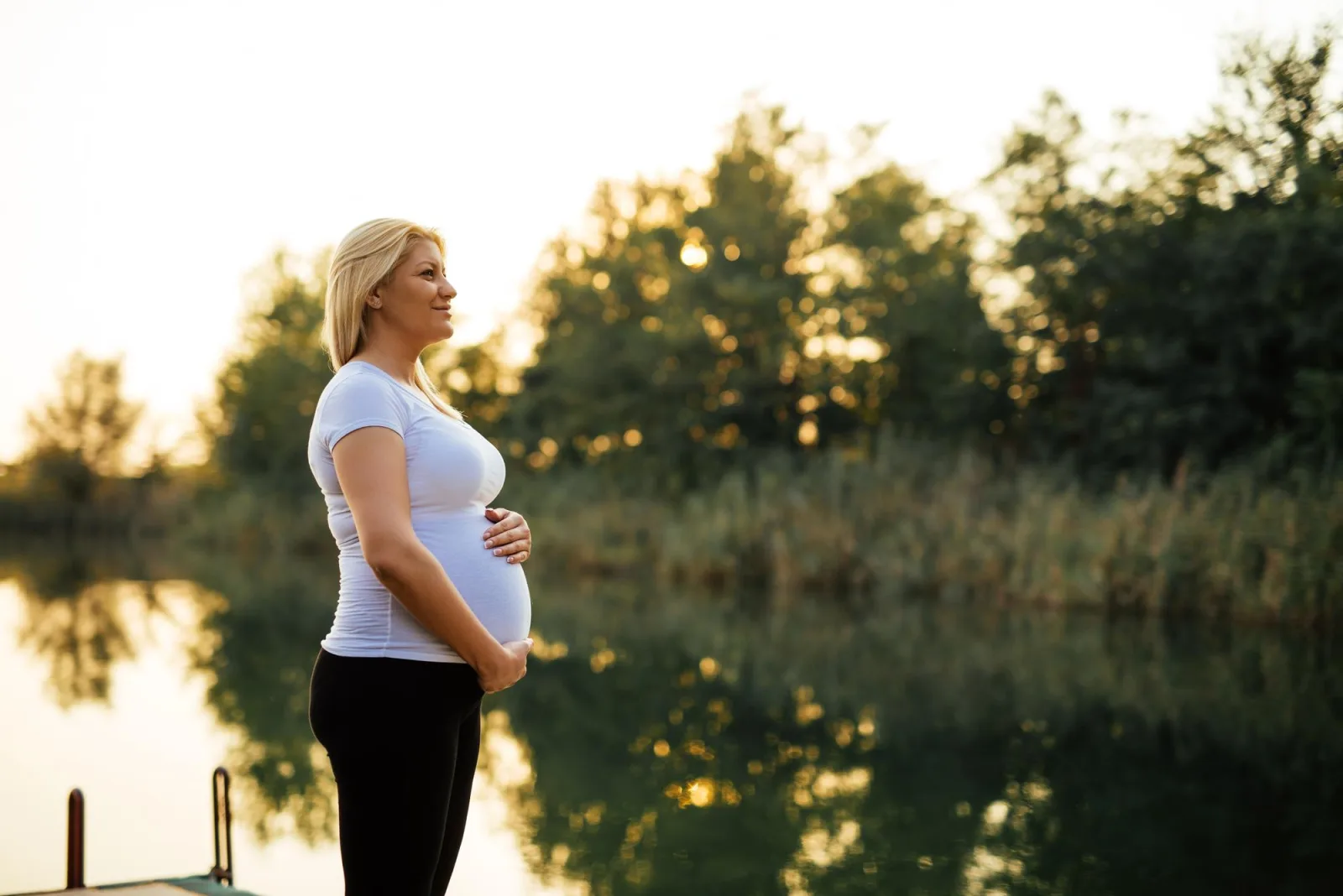 Woman enjoying nature on a river dock