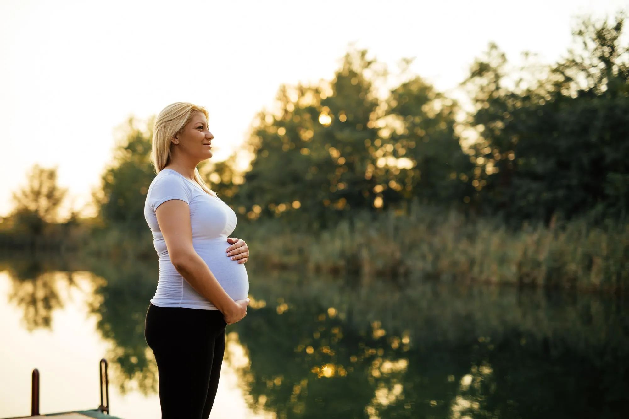 Woman enjoying nature on a river dock