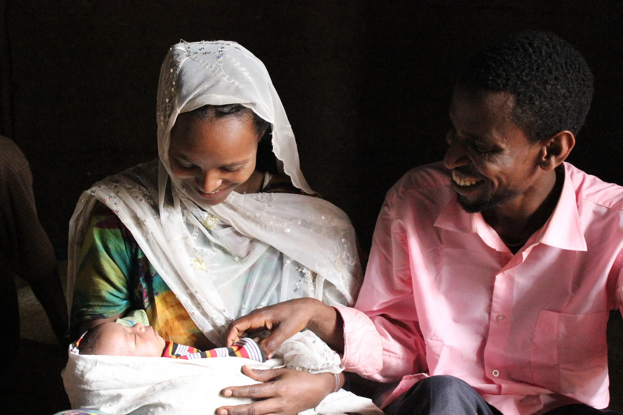 Nefisa is a 24-year-old farmer who lives in the Oromia Region. Five years ago, she gave birth to her first child at home, which is the customary practice. Mothers feel more comfortable at home. However, her labor was prolonged and it was a difficult birth and bore risks to her and to her newborn. Due to that experience, Nefisa took advantage of the advice of health extension workers and the Last Ten Kilometers project, who encouraged her about the safety of delivering at a health center. Many women fear mistreatment at impersonal health centers and are reluctant to go. In Ethiopia, births without the support of a professionally trained birth attendant or midwife account for a high rate of newborn and maternal deaths or birth injuries.
Three weeks after Nefisa delivered a healthy baby at the Shebe Health Center, she happily relates with her husband at her side how everything went smoothly and swiftly. She was especially impressed with the efficiency of Abdulahi Abaselam, the professionally trained birth attendant, who, untypically was a male, and how assuring he was. Abdulahi received basic emergency obstetric and newborn care training provided by the Last Ten Kilometers project, which receives USAID support and is implemented by JSI.
Photo: Adey Abebe, JSI Last Ten Kilometers project