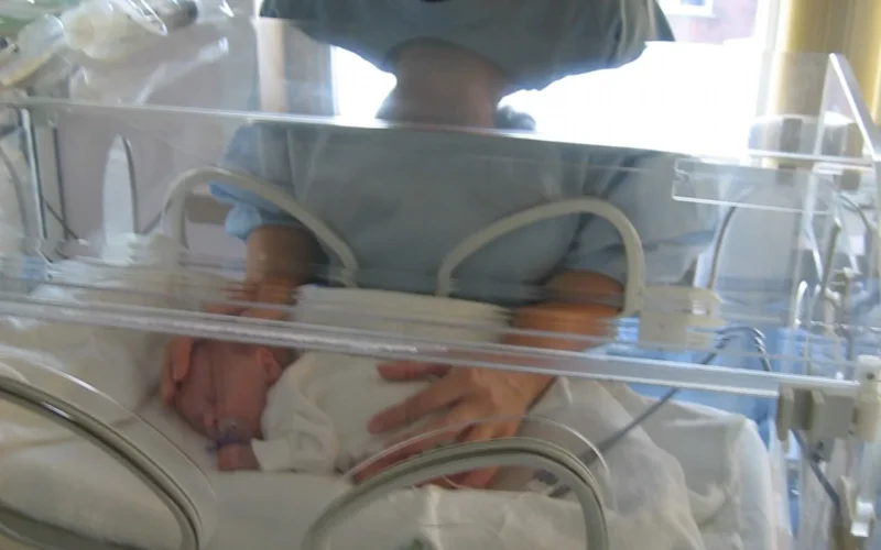 Mother with premature baby in an incubator