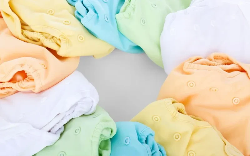 A top-view of colorful cloth diapers arranged in a circular pattern showcasing vivid hues and comfort.