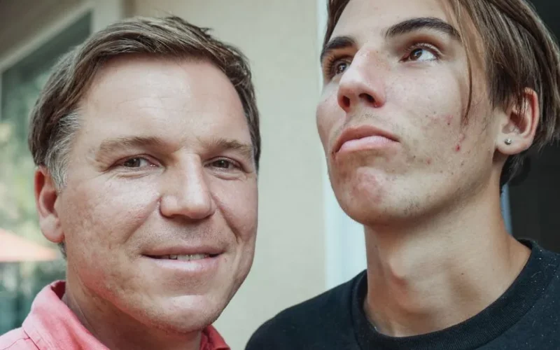 Close-up of father and teenage son posing together, showcasing family resemblance and natural expressions.