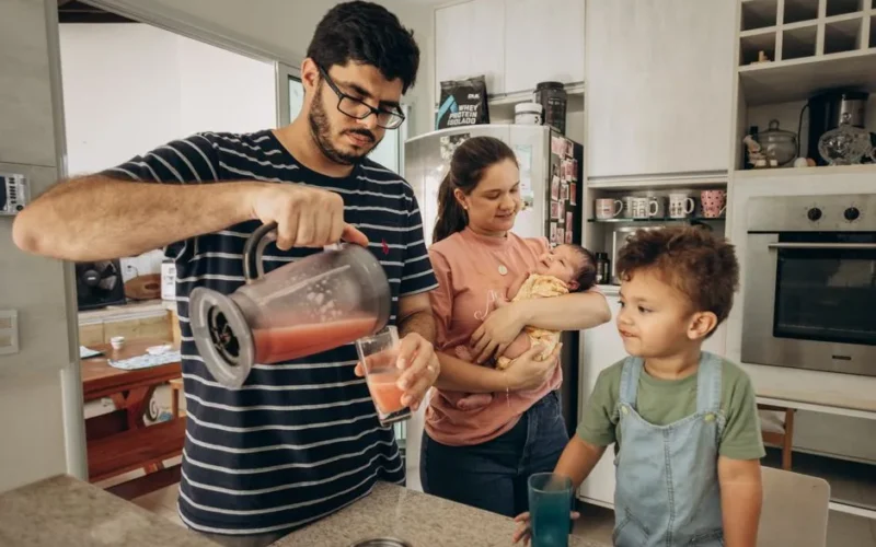 A family enjoys a morning together in their kitchen, making fresh juice.