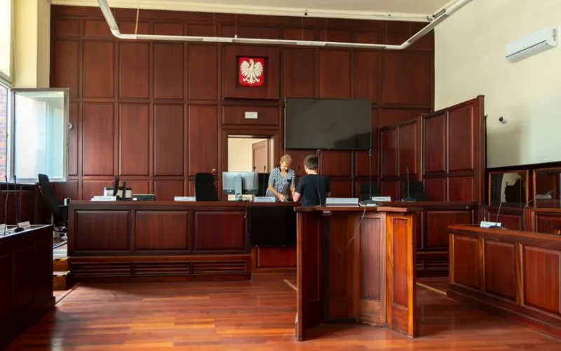 Spacious Polish courtroom with wooden panels and furniture located in Wrocław, Lower Silesia.